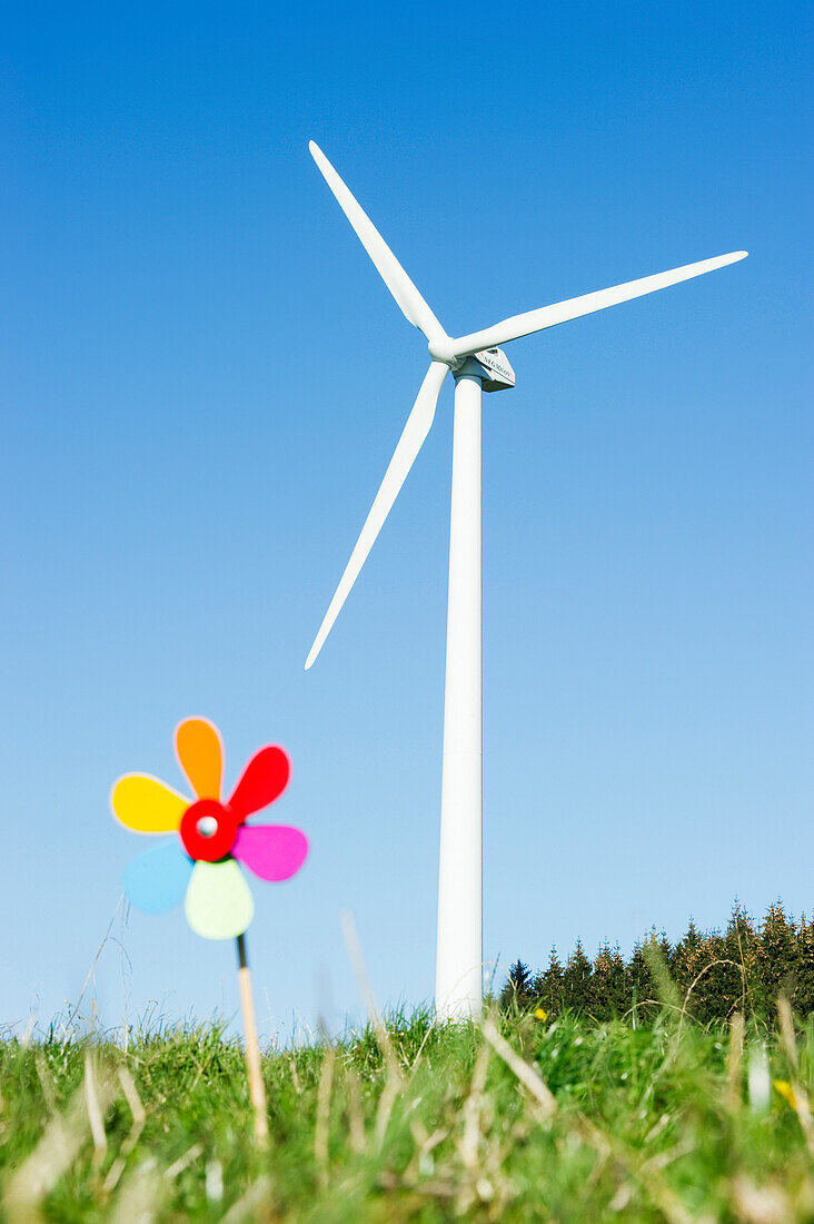 Toy windmill and large wind turbine, Black Forest, Baden-Wurttemberg, Germany