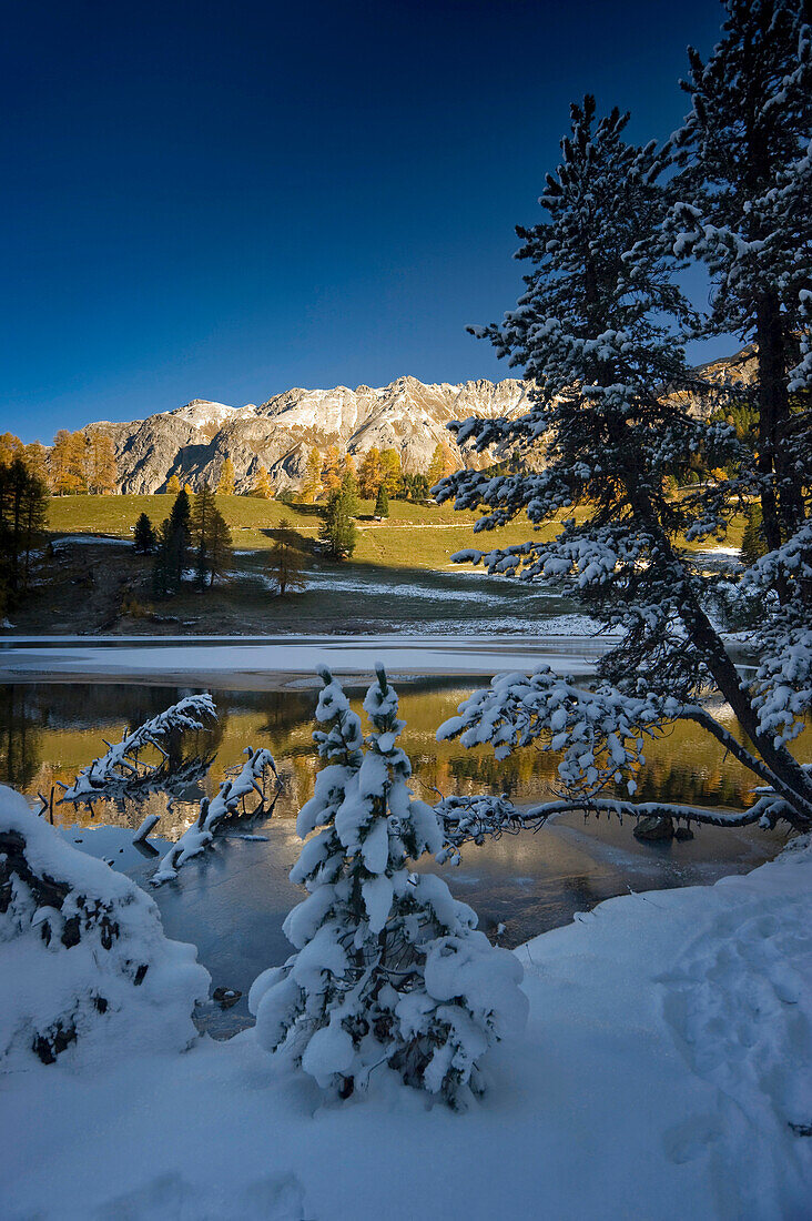 Reflection of mountains in Lake Palpuoga, Bergun, Grisons, Switzerland