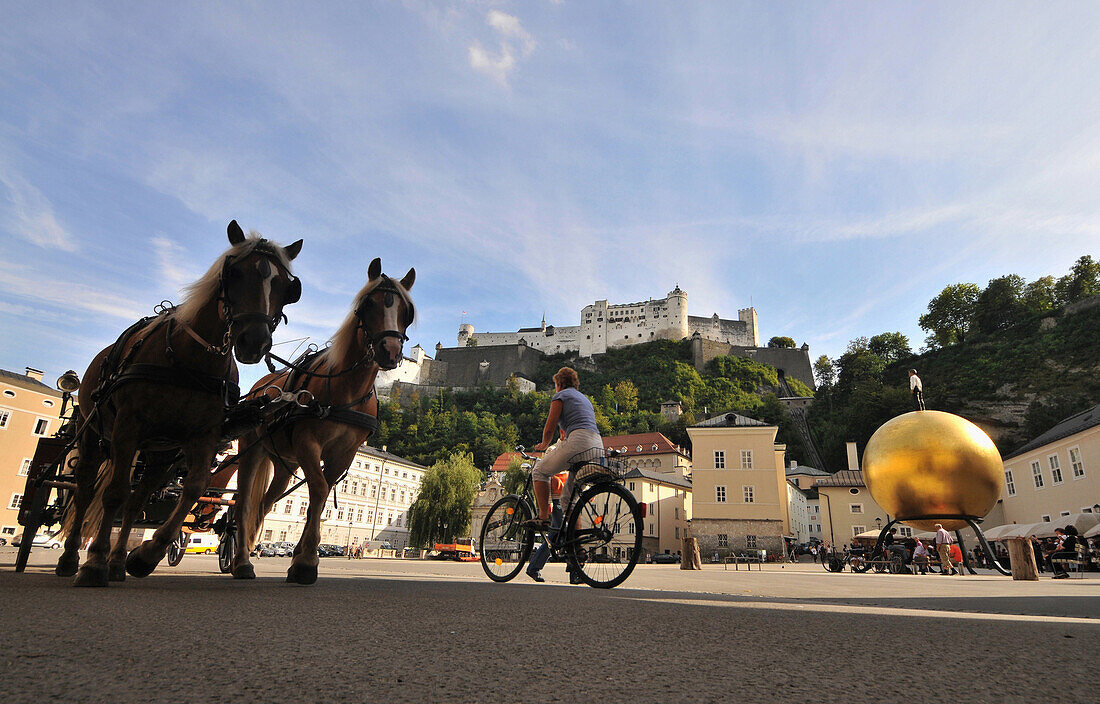 Horse and carriage at Kapitel square, Hohensalzburg Fortress in the background, Salzburg, Austria