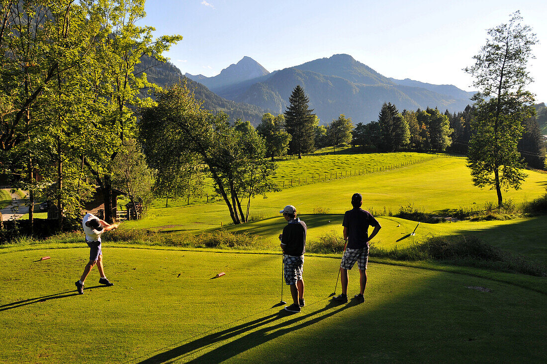 Teenagers playing golf, Golf club Goldegg in Pongau, Salzburg-land, Austria