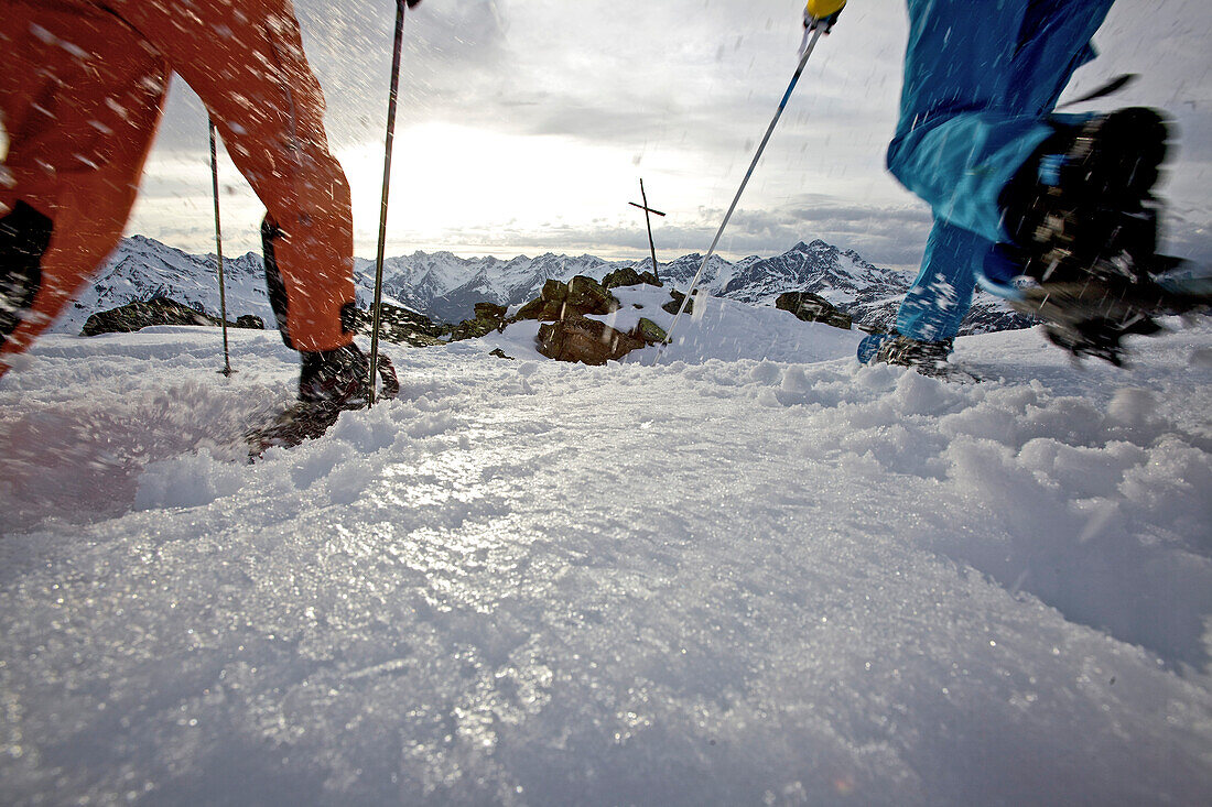 Young women hiking up the mountain in their snowshoes, See, Tyrol, Austria