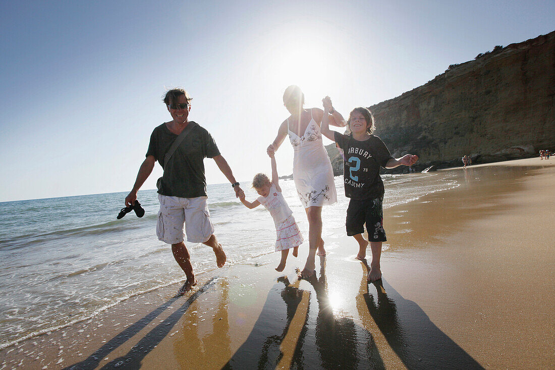 Family walking along the beach, Conil de la Frontera, Costa de la Luz, Andalusia, Spain