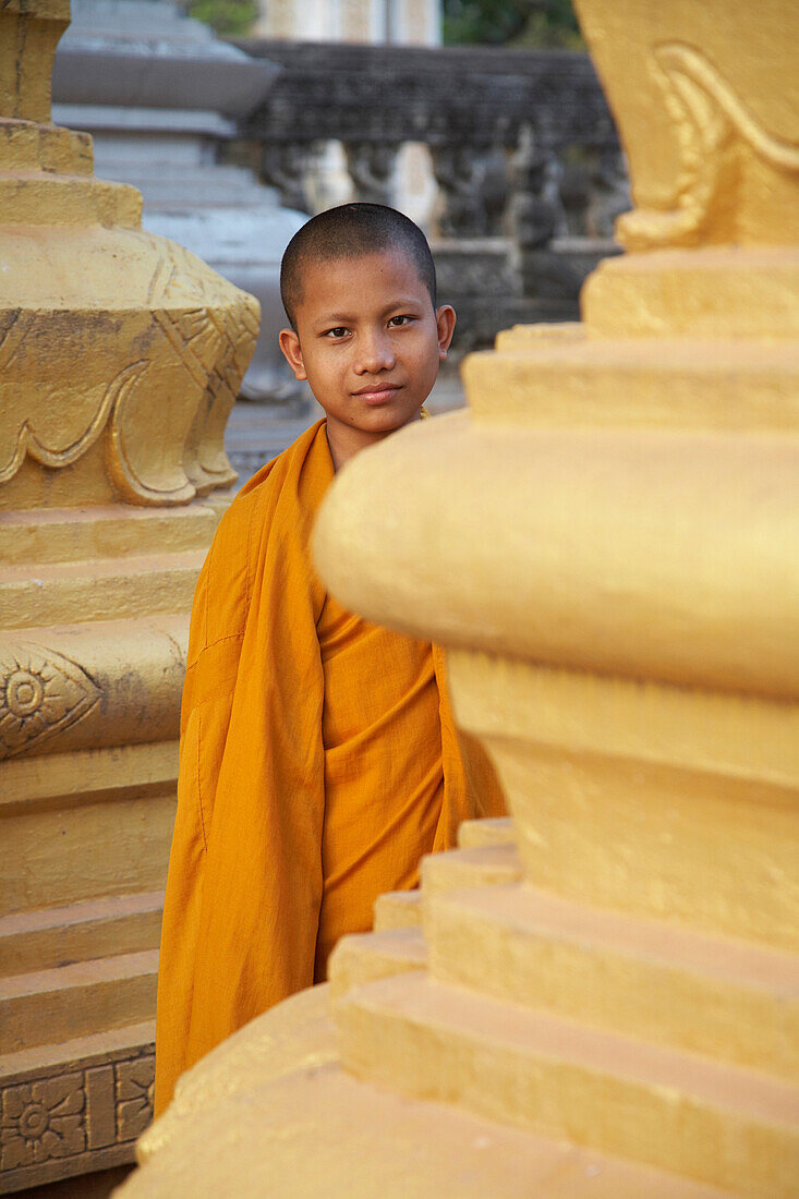 Portrait of young monk between pillars, Wat Bo Temple, Siem Reap, Cambodia