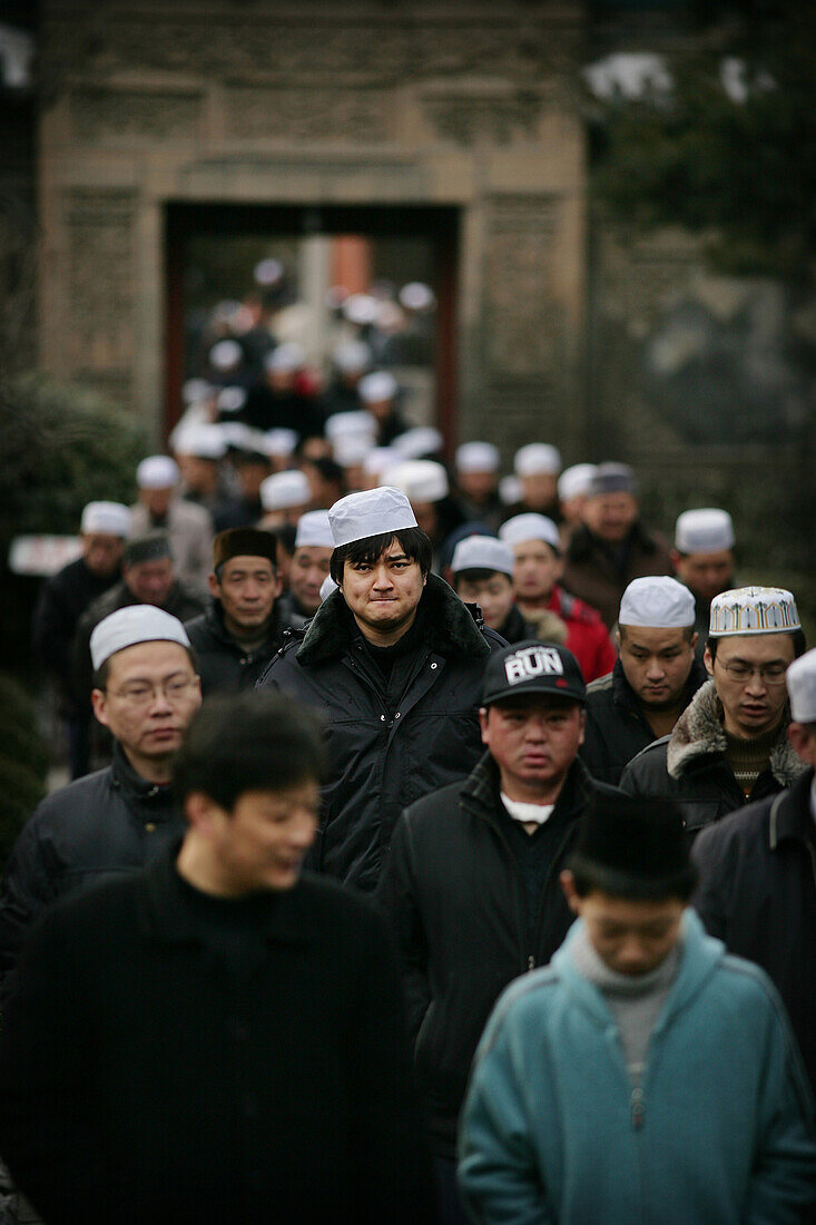 The Hui community, Chinese Muslims, arrive at a mosque for Friday Prayers, Xian Great Mosque, Xian, Xi'an, Capital of Shaanxi Province, China