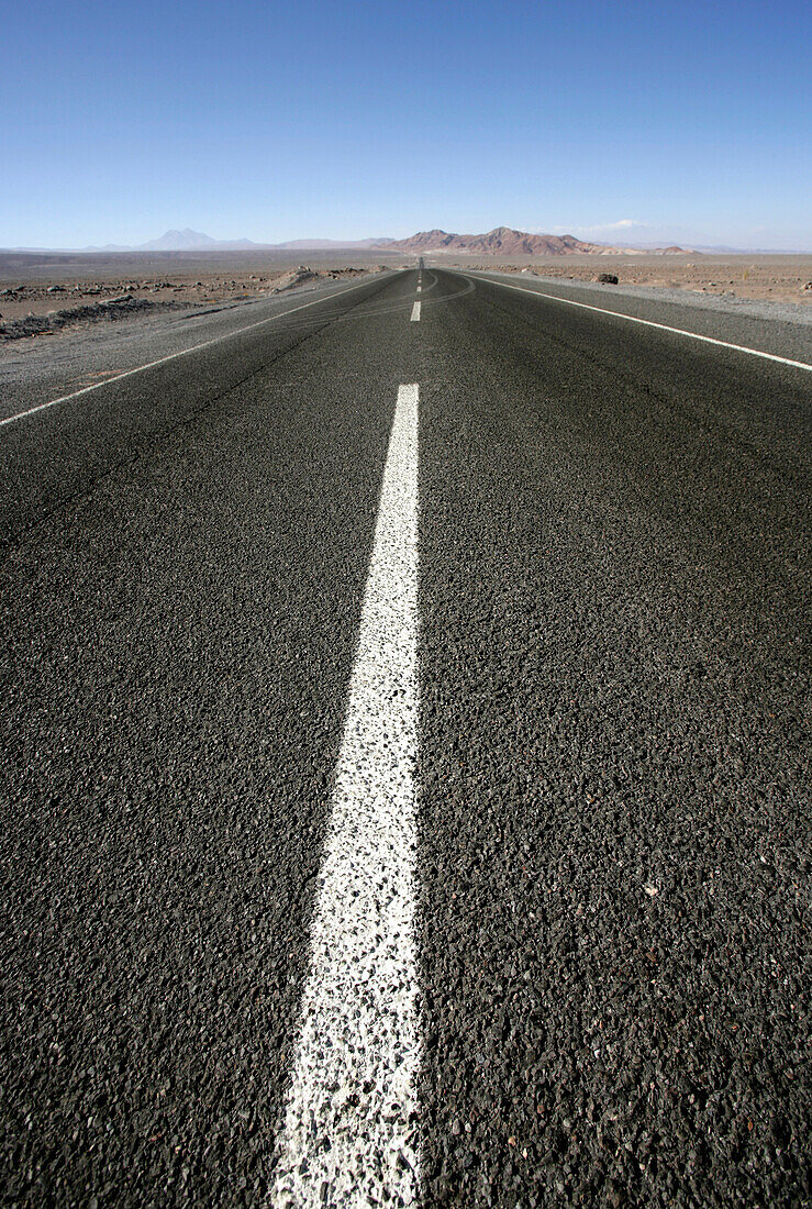 Dividing line on empty, paved road, Low Angle View, Road between Chile and Argentina, Andes, San Pedro de Atacama, Chile