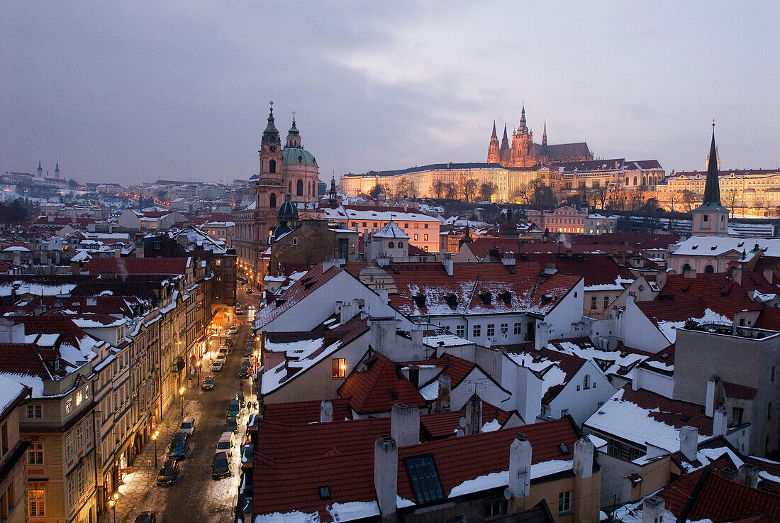 St Nicholas church and Prague castle in the Little Quarter on a Winter's evening, Prague, Czech Republic