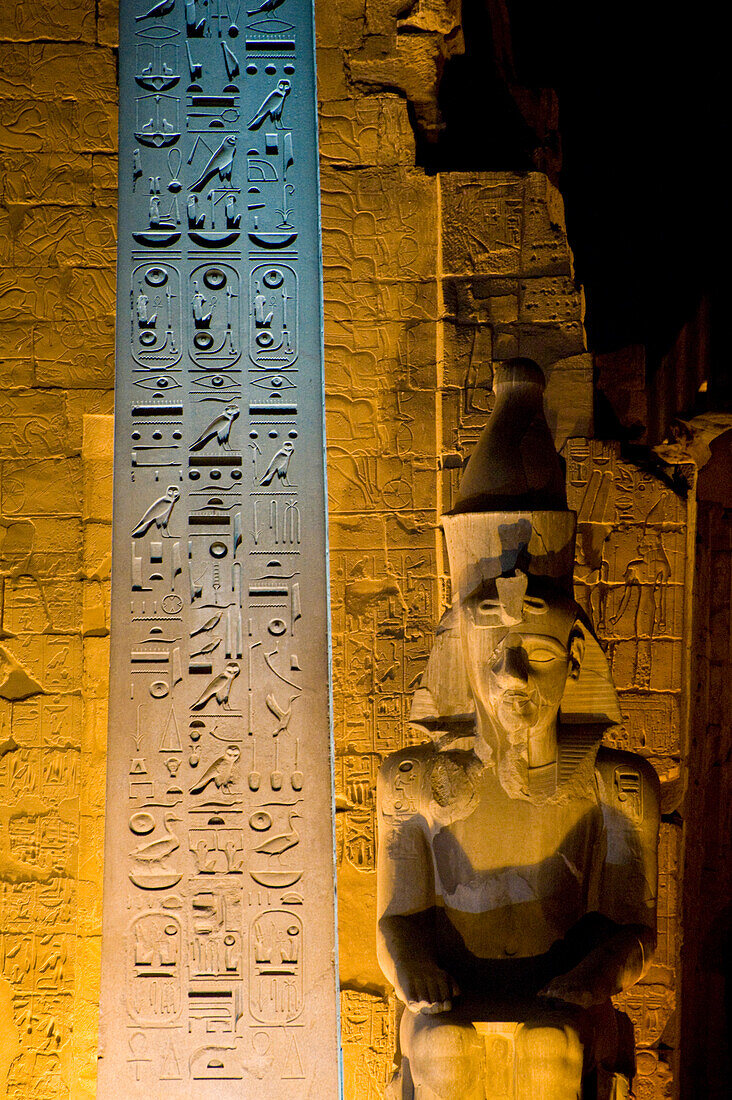Detail of entrance to Luxor Temple with Obelisk and Colossus of Ramses II at dusk, Luxor, Egypt