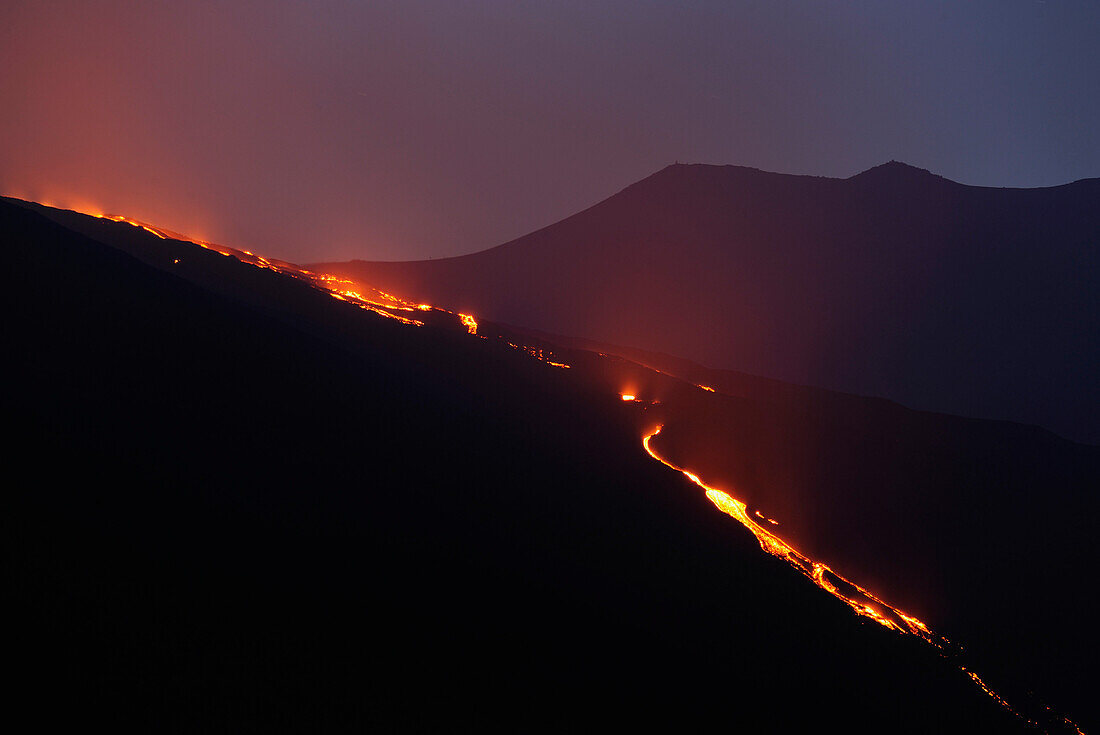 Italy, Sicily, red lava flow in the Valle del Bove at night