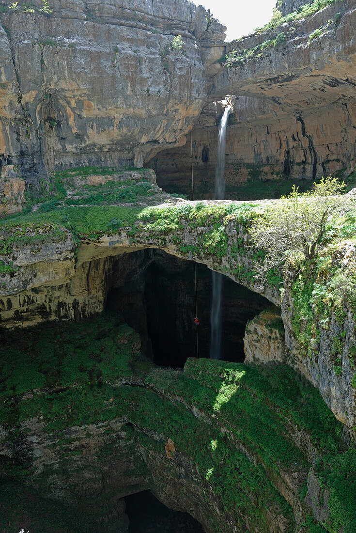 Speleology, caving, underground world,entrance pit with waterfall and natural bridge, Ballouh Balaa (Lebanon)