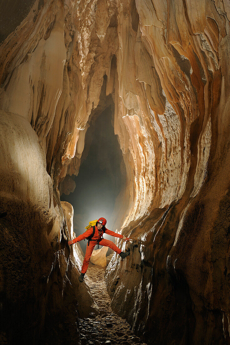 Speleology, caving, caver in a vertical gallery, Grotte de la Cocalière, Gard, France