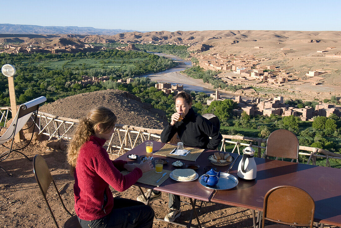 Morocco, Roses Valley,  El Kelaa M'gouna, two women having breakfast on a terrace