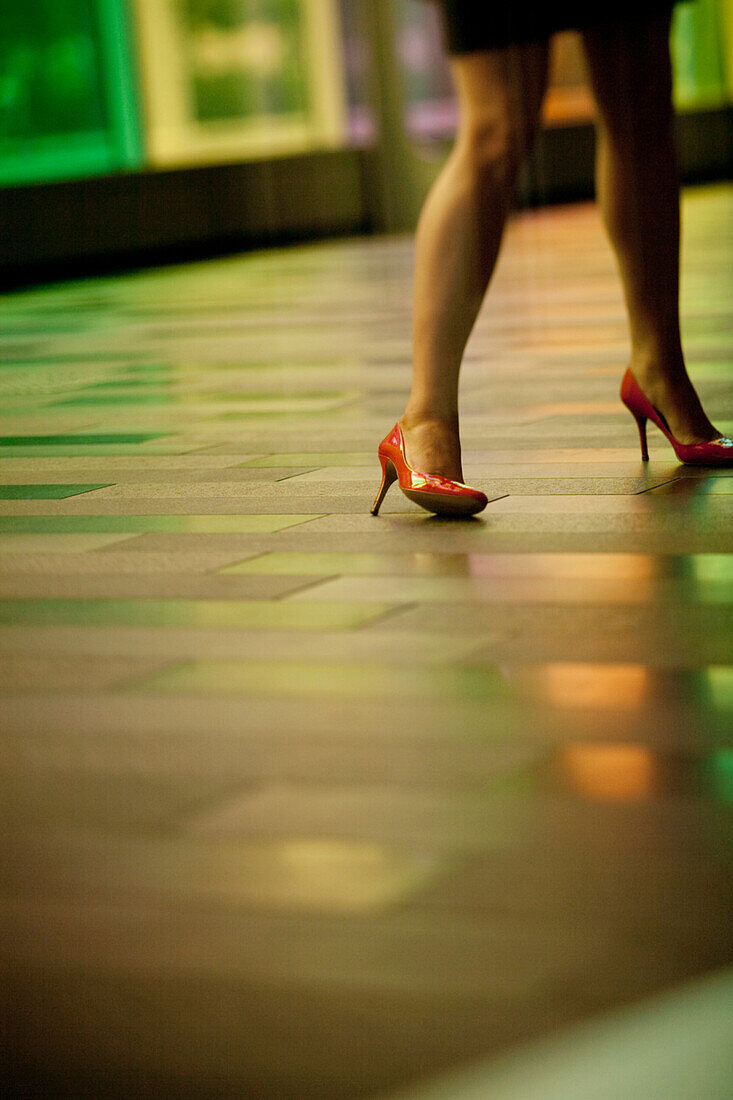 Woman's legs walking in the street, heel shoes