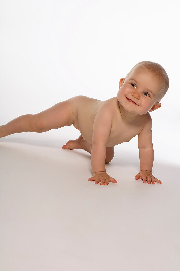 Naked baby girl crawling