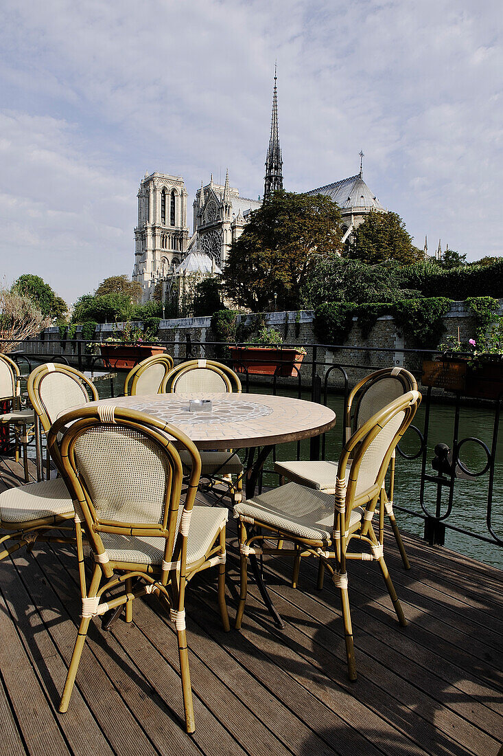 France, Paris, restaurant terrace on a barge, Notre Dame cathedral in background