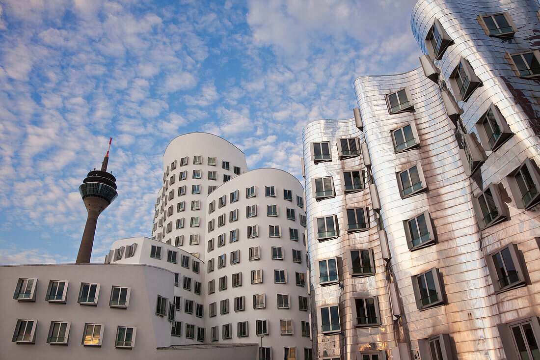 Rheinturm tower and  buildings under clouded sky, Neuer Zollhof, Media harbour, Duesseldorf, North Rhine-Westphalia, Germany, Europe