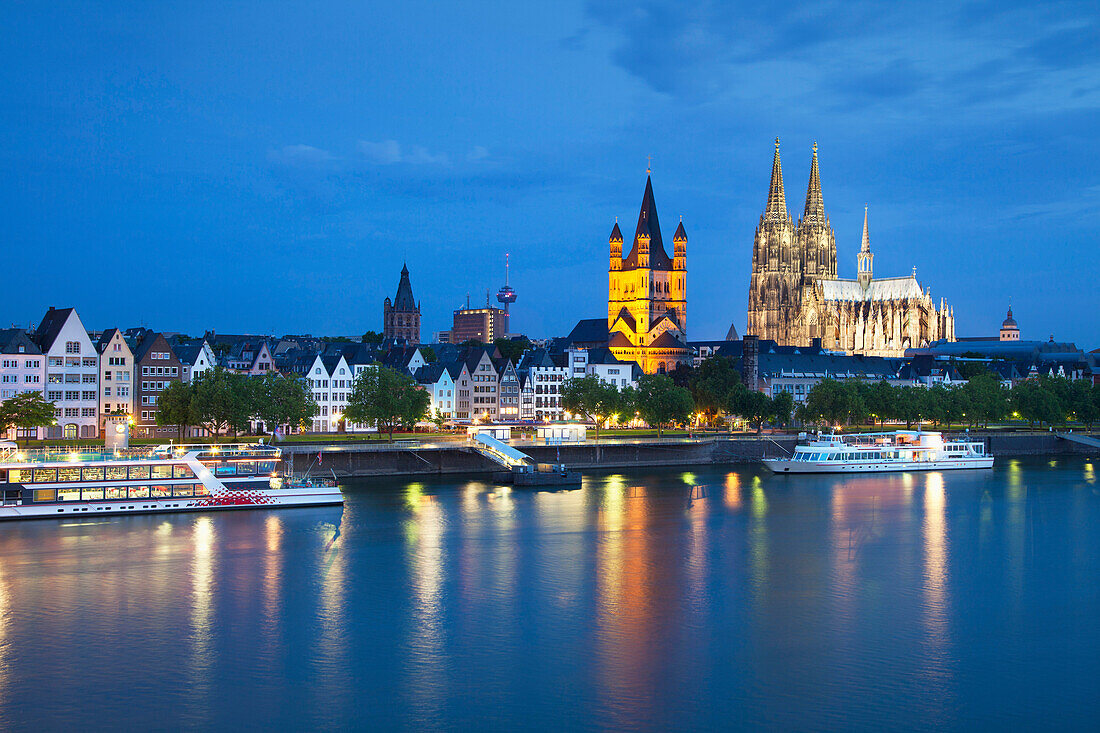 View over the Rhine river to church Groß St. Martin and cathedral in the evening, Cologne, North Rhine-Westphalia, Germany, Europe