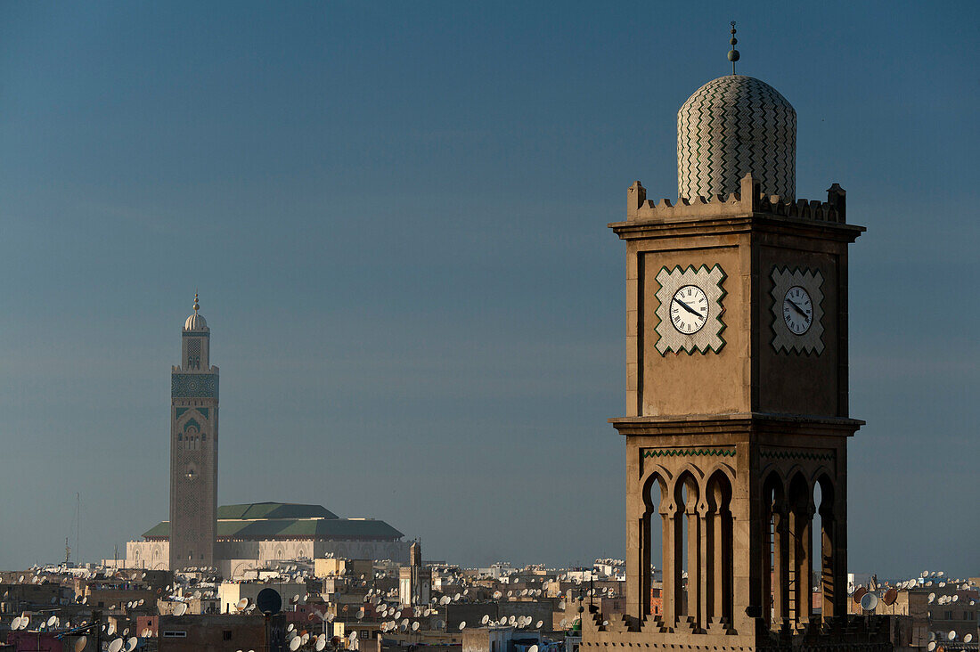 Looking past old clock tower to the Mosque Hassan II, Casablanca, Morocco