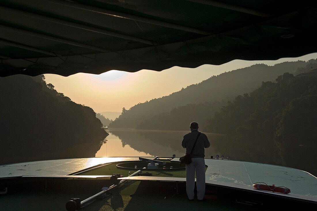 Old man enjoying sunrise on Douro Valley River Cruise, Portugal