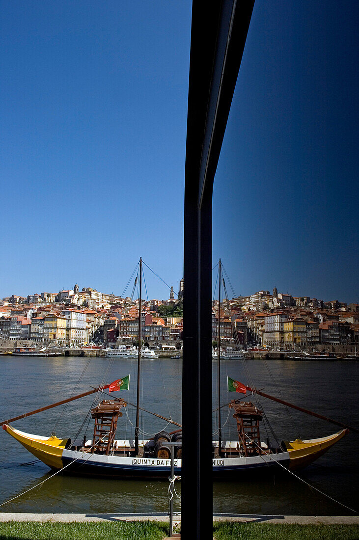 A view of the city of Oporto partly reflected on a glass window, Portugal