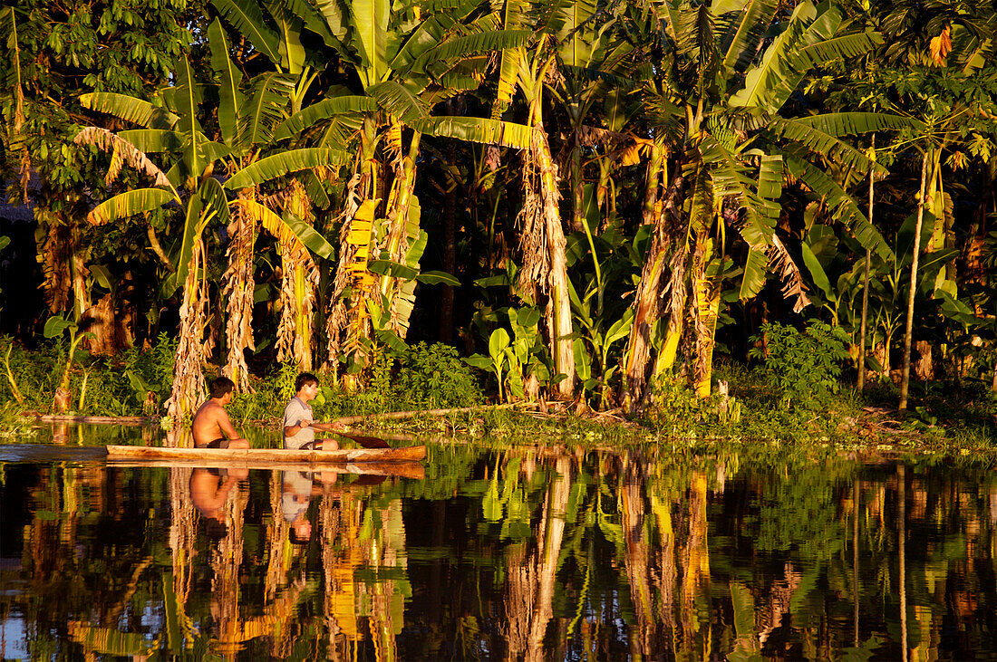 Two people in canoe on river, Peru