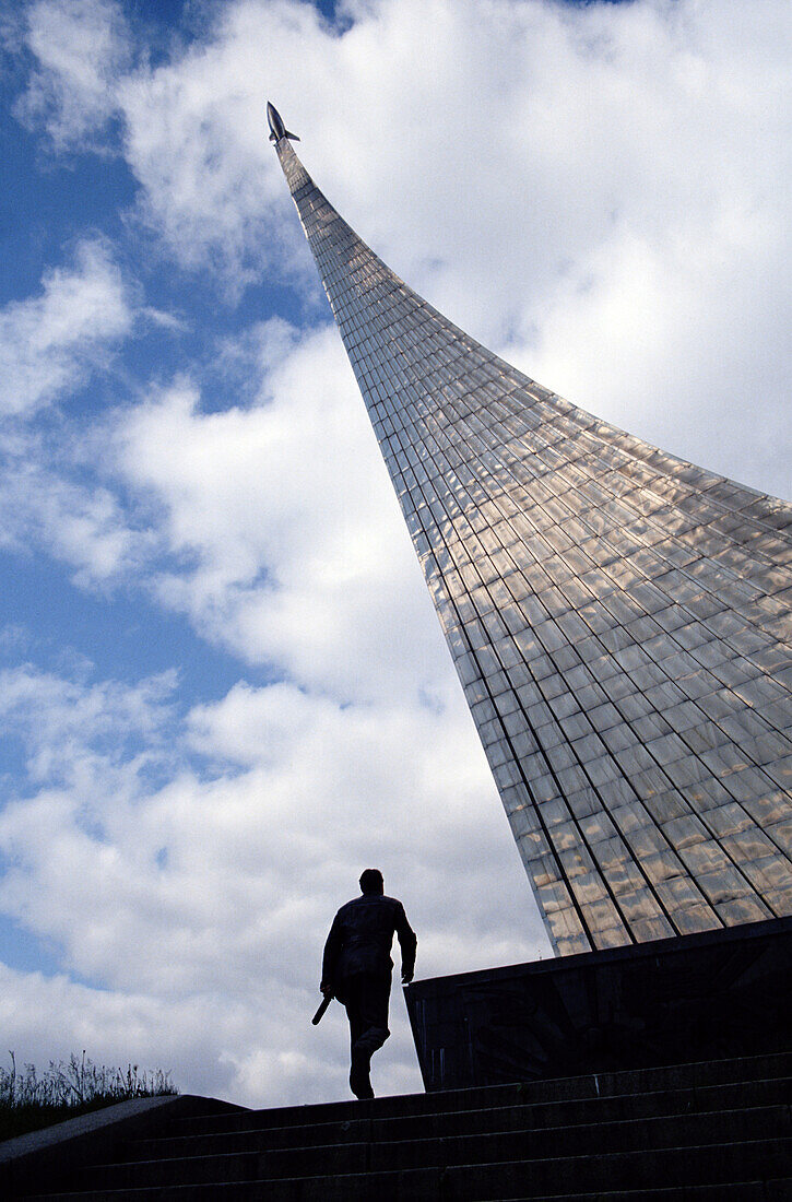 A man passes a monument to honor Russian space exploration, Moscow, Russia
