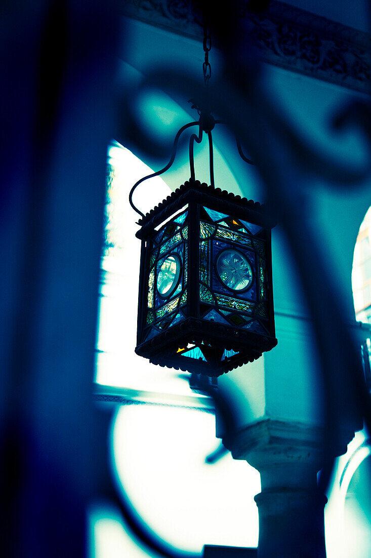 Moorish lantern hanging in courtyard, Seville, Spain