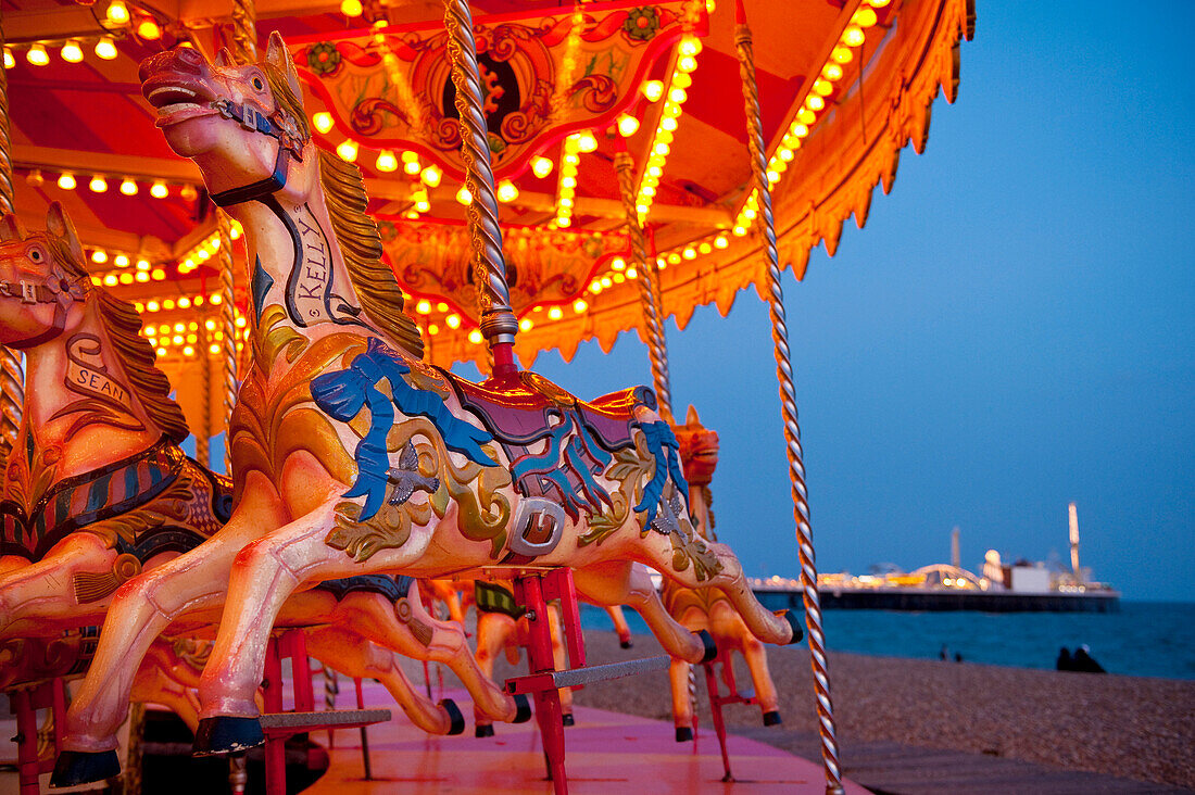 Merry-go-round on Brighton beach at dusk, Brighton, East Sussex, UK.