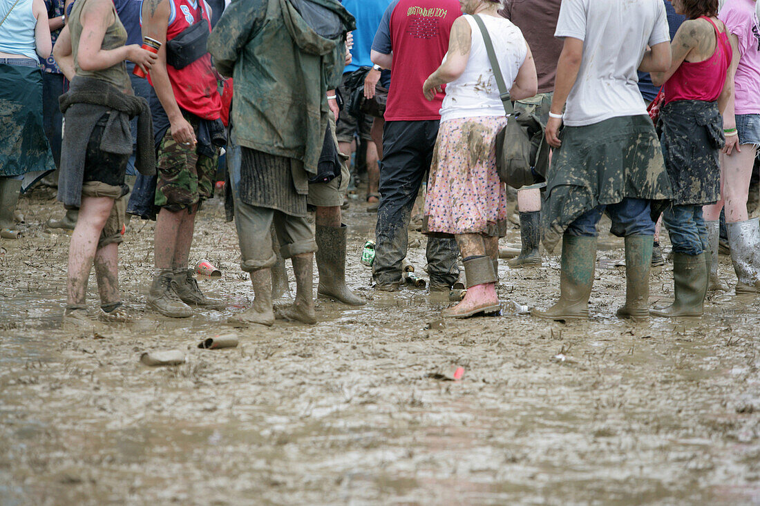 Muddy legs at Glastonbury Festival, Somerset, England