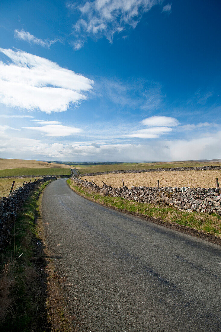 Road through countryside near Ingleton, North Yorkshire, England, UK