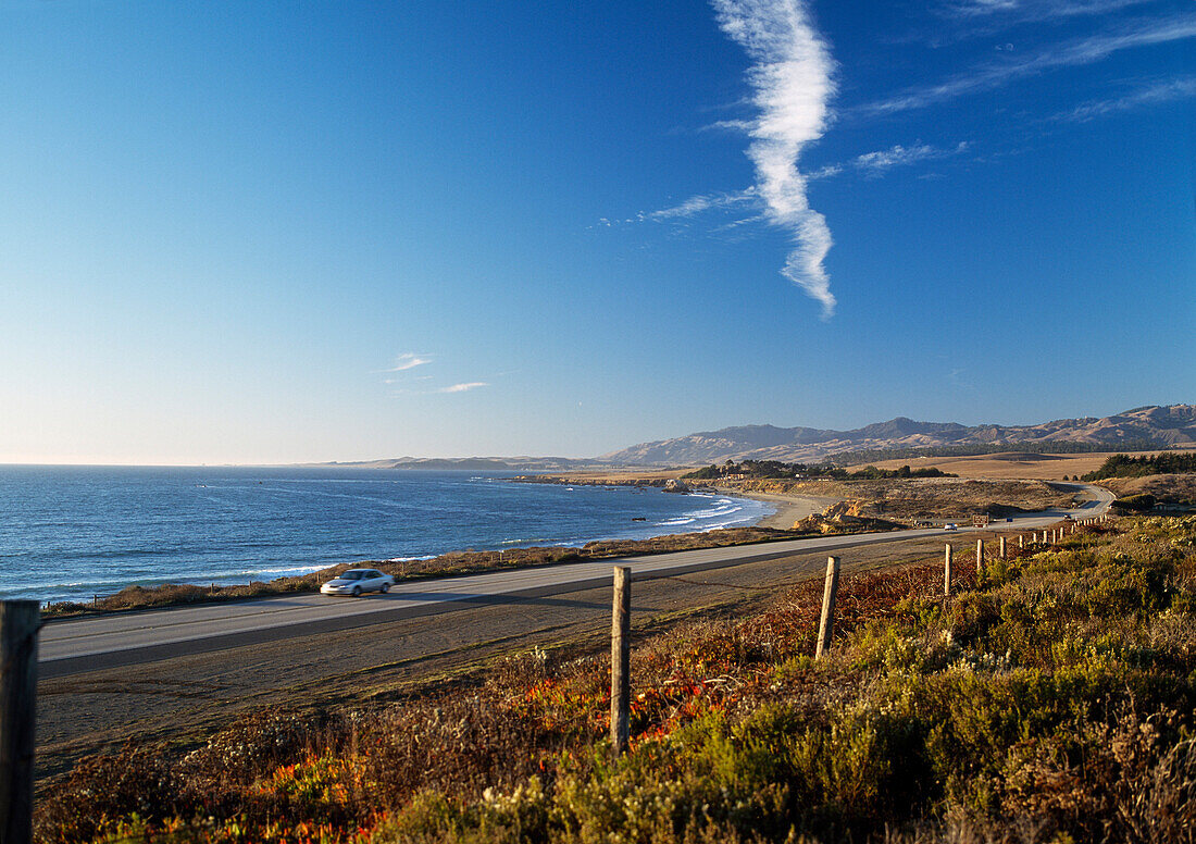 Car traveling on Route 1 along the Big Sur coastline, Near San Simeon, California