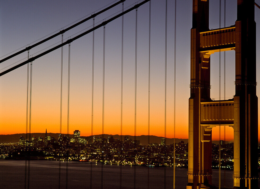 Detail of the Golden Gate Bridge at dawn with San Francisco behind, California