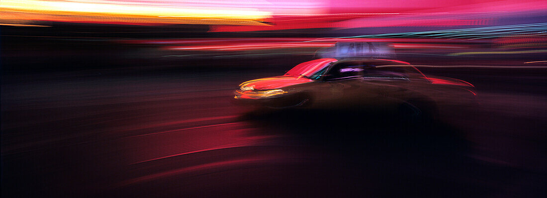 Speeding yellow taxi in Times Square, blurred motion, New York City, New York State, USA