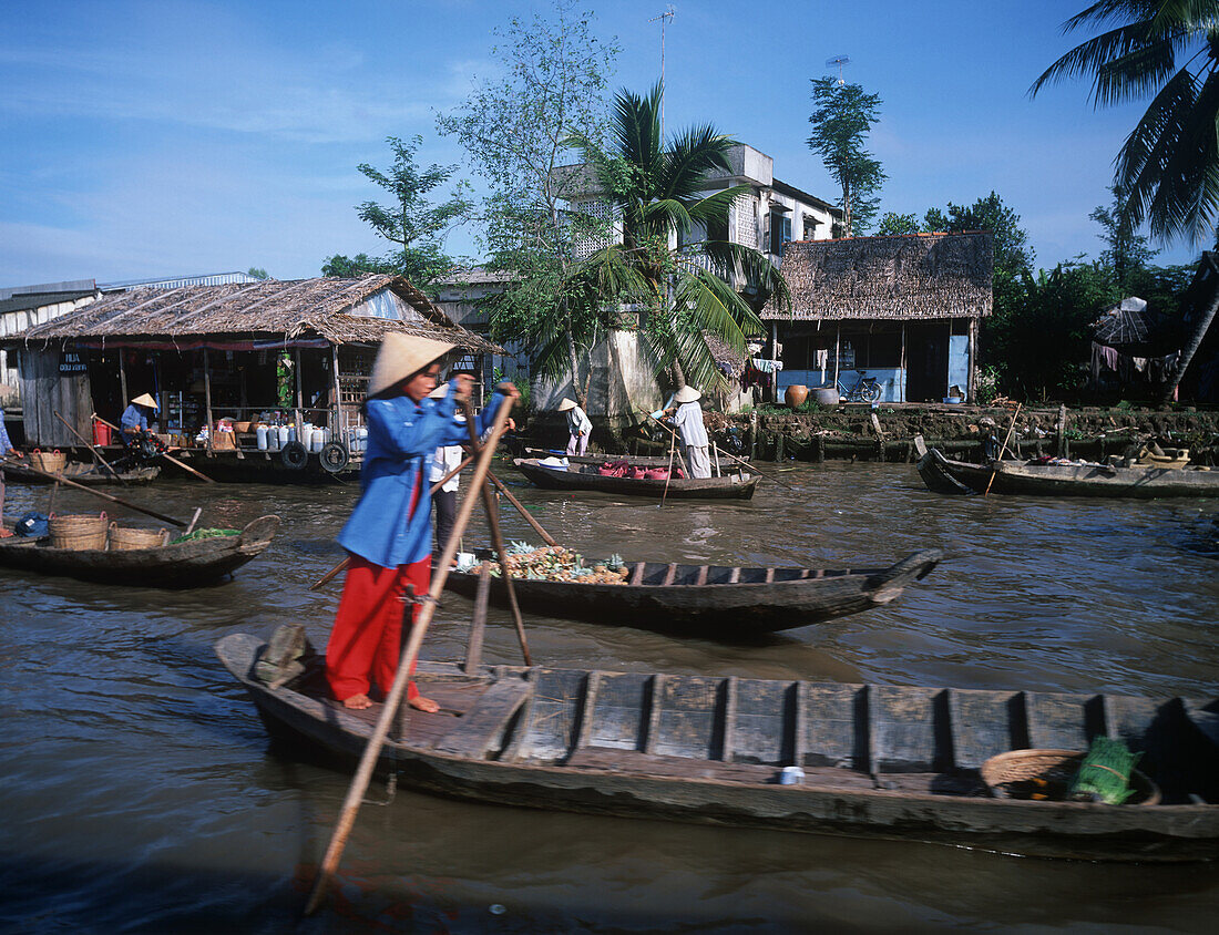 Women rowing, Mekong Delta, Vietnam
