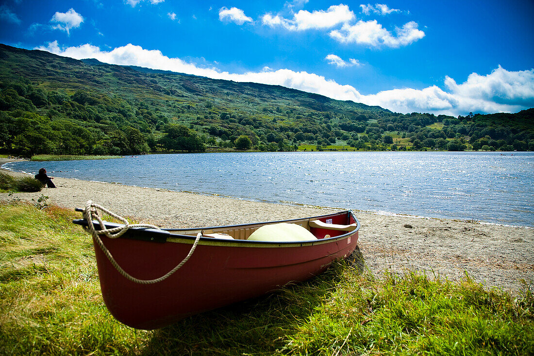 'Canoes/ kayaks available for families to rent, to be used in the river and lake. Nant Gwynant Lake glistening in the sun, Llyn Gwynant Campsite, Nantgwynant, Snowdonia National Park, North Wales'10;'