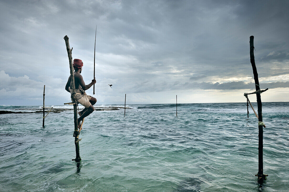 Stilt Fisher fishing, Koggala, Weligama Bay, stilt fishing is only done worldwide in Sri Lanka, around Unawatuna, Sri Lanka