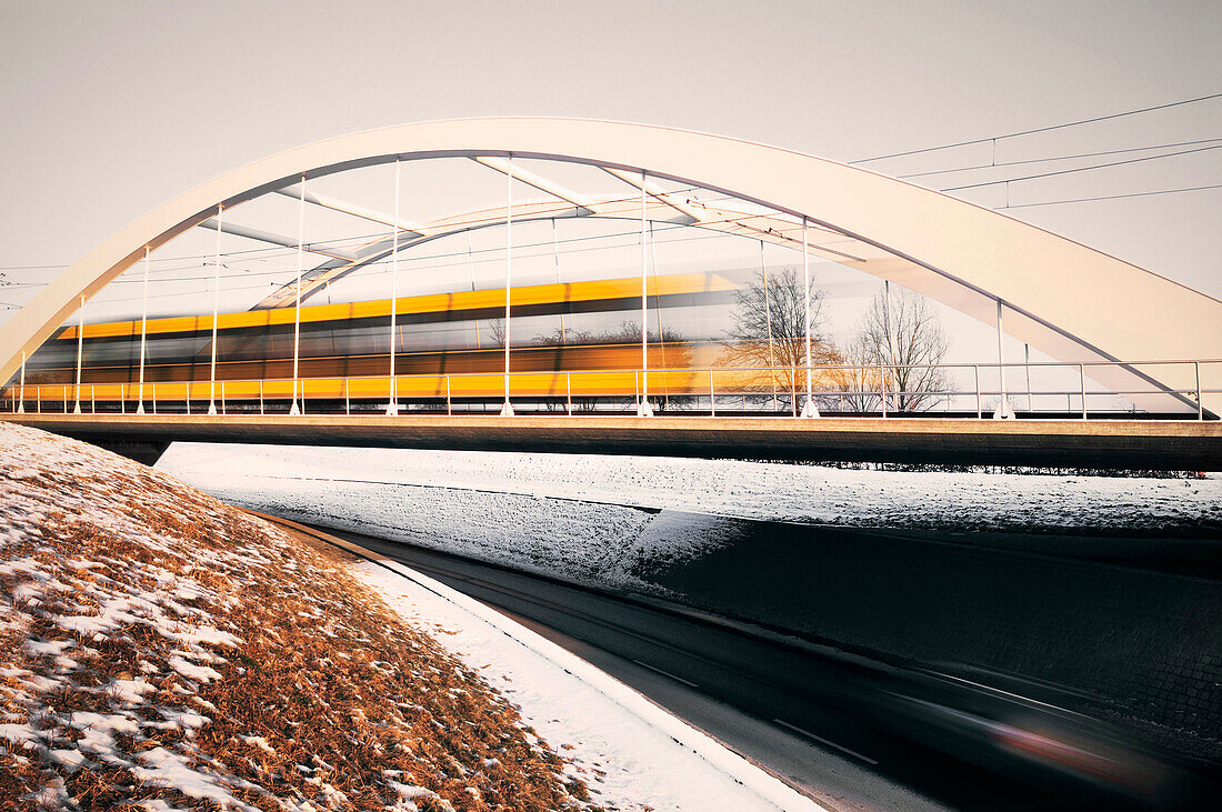 Train passing a bridge at Scharnhauser Park, Ostfildern, Stuttgart, Baden-Weurttemberg, Germany