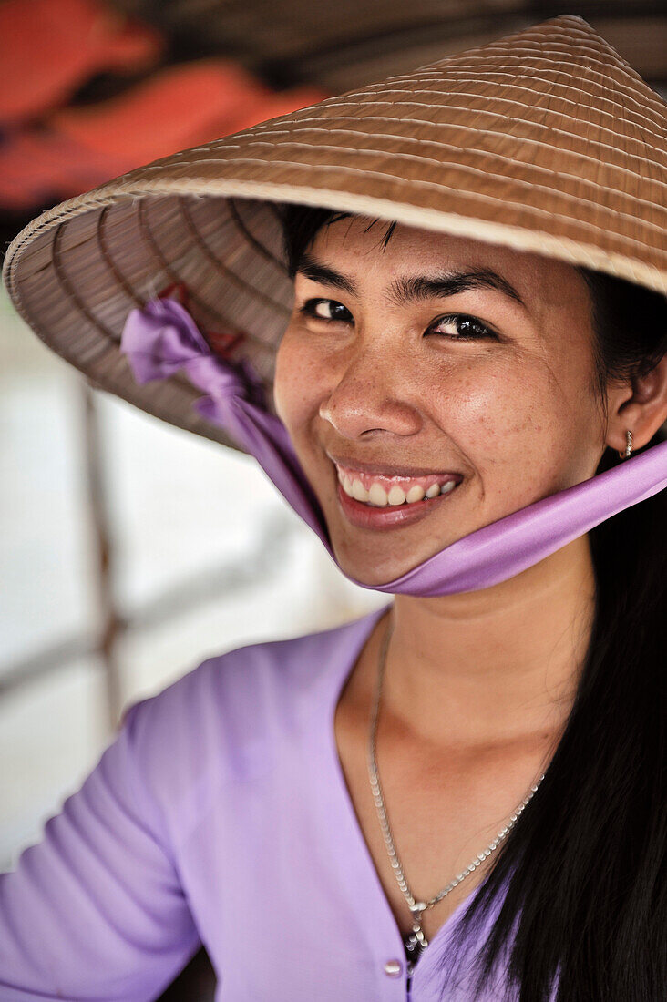Vietnamese woman with hat smiles while being portraited, Mekong Delta, Vietnam
