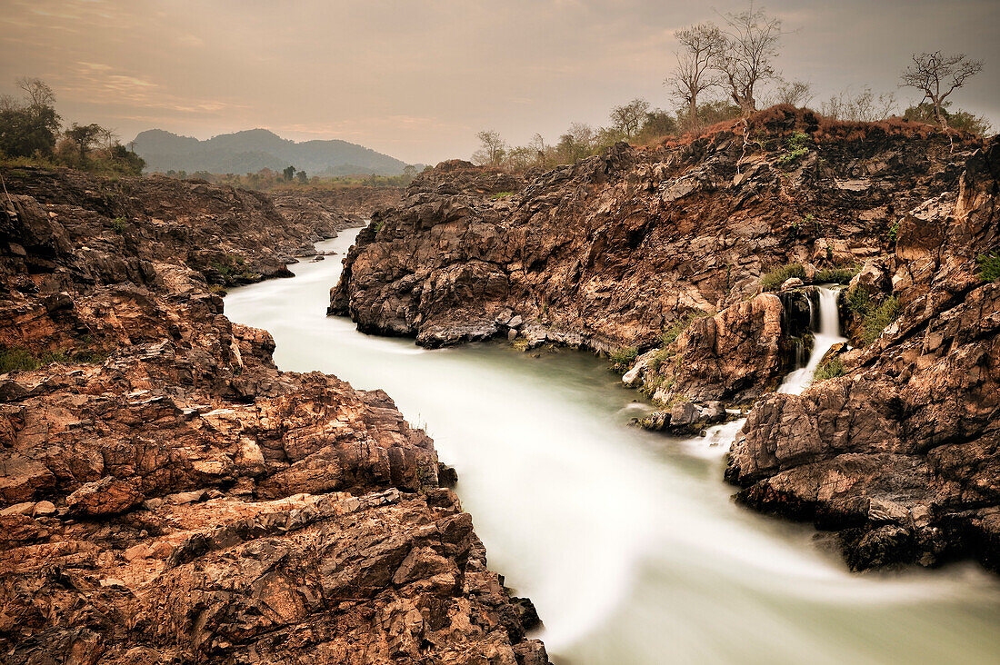 Ausläufer eines Wasserfalls durch schroffe Felsen, Don Khon, Si Phan Don 4000 Inseln, Mekong Fluss, Laos, Langzeitbelichtung