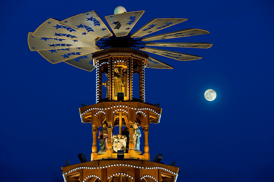 Christmas pyramid with full moon at the Christmas market, Karlsruhe, Baden-Wuerttemberg, Germany