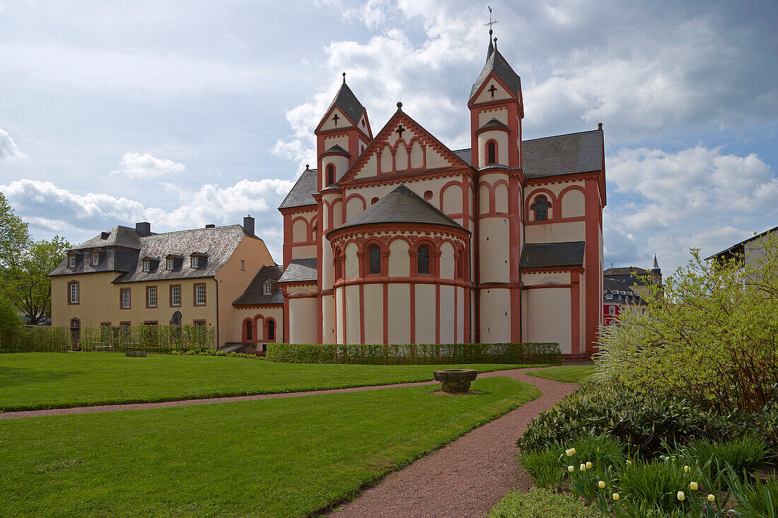 St. Peter's church with garden under clouded sky, Merzig, Saarland, Germany, Europe