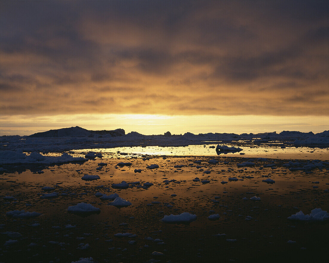 Midnight sun over snowy Disko Bay, Greenland