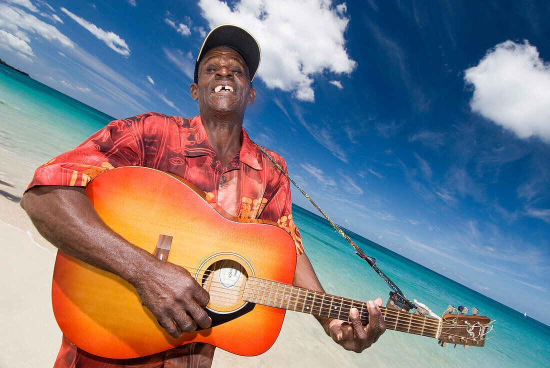 Calypsonian playing his guitar, Grand Anse Beach, Grenada