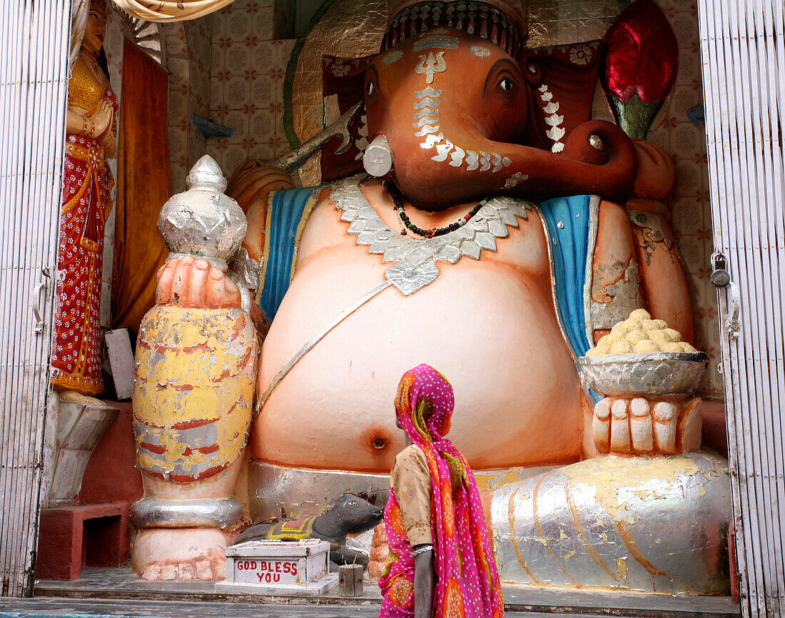 Woman looking at Ganesha, Deogarh Village, Rajasthan, India
