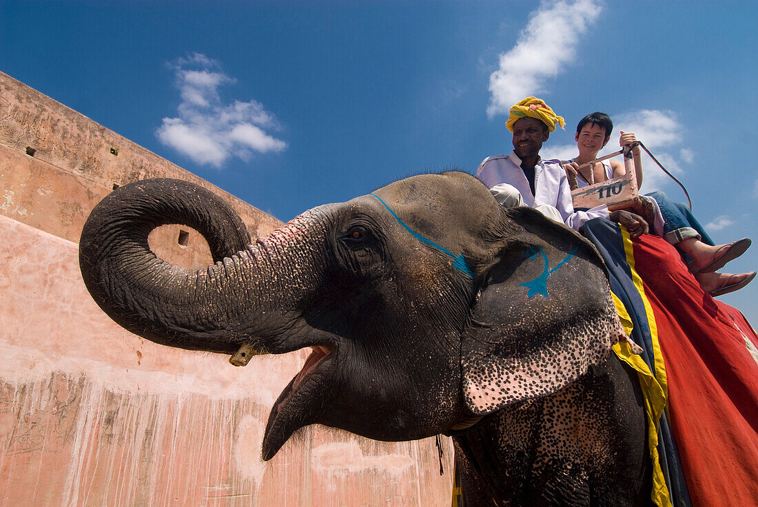 Mahout and tourist on elephant, Amber Fort near Jaipur, Rajasthan, India