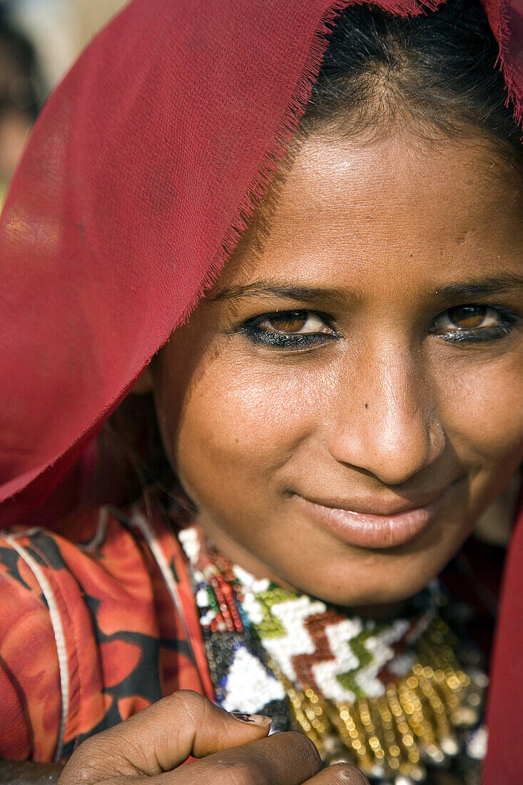 Young woman in traditional red sari, Pushkar, Rajasthan, India
