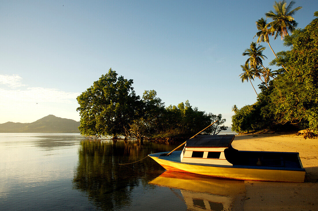 Boat on sandy beach, Bunaken, Sulawesi, Indonesia