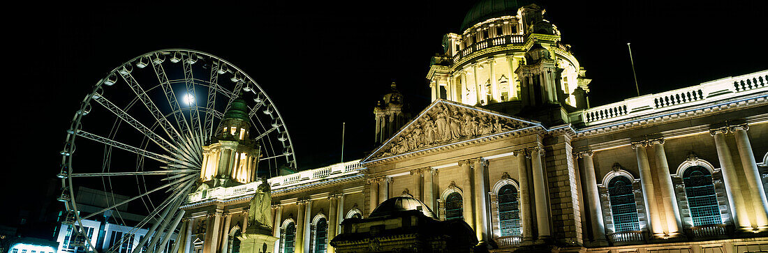 Moon rising behind Big Wheel and Belfast City Hall, Belfast, Northern Ireland
