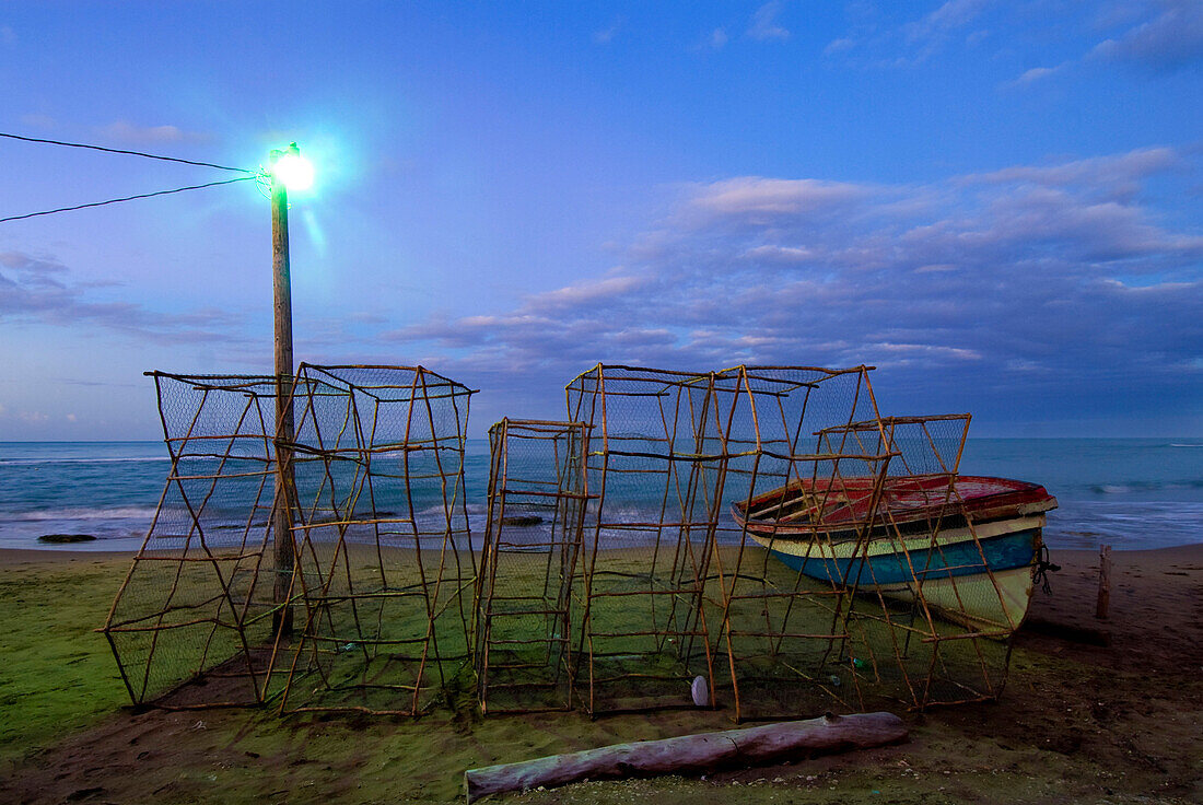 Lobster pots at the coast, Lobster pots beside fishing boat at dawn, Treasure Beach, Jamaica.