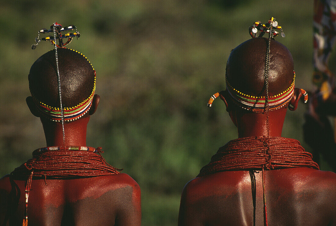 Young Samburu tribal girls wearing red necklaces, rear view, Ol Mayo, Kenya