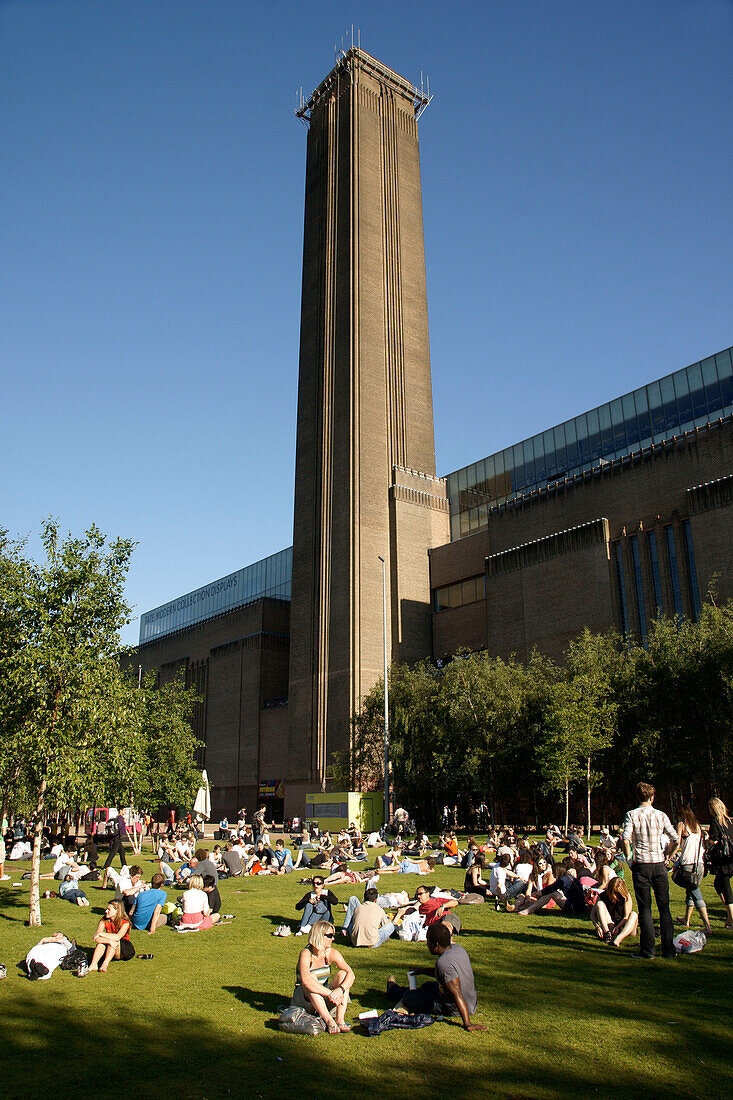 The Tate Modern and people enjoying the late afternoon sunshine on the Southbank of the Thames, London, England, UK, London, England, UK
